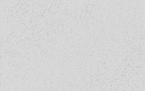 Nahaufnahme einer hellgrauen Raufasertapete mit vielen kleinen, erhabenen Kügelchen. Perfekt, um die Textur vor dem Streichen zu zeigen.